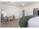Bright bedroom with a large mirror, a chair, and a ceiling fan, creating a cozy and inviting space at 9429 W Sandstone Mountain Dr, Casa Grande, AZ 85194