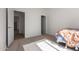Bright bedroom features neutral walls, carpet, and modern doors for a clean and minimalist aesthetic at 9429 W Sandstone Mountain Dr, Casa Grande, AZ 85194