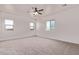 Expansive bedroom featuring a ceiling fan, plush carpet, and three bright windows at 9429 W Sandstone Mountain Dr, Casa Grande, AZ 85194