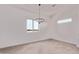 Bright dining room with a modern chandelier and natural light from two windows at 9429 W Sandstone Mountain Dr, Casa Grande, AZ 85194