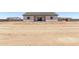 Rear exterior featuring a covered patio and a desert landscaped backyard at 9429 W Sandstone Mountain Dr, Casa Grande, AZ 85194