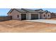 Charming single-story home featuring a spacious three-car garage and a low-maintenance desert landscape at 9429 W Sandstone Mountain Dr, Casa Grande, AZ 85194