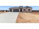Charming single-story home featuring a spacious three-car garage and a low-maintenance desert landscape at 9429 W Sandstone Mountain Dr, Casa Grande, AZ 85194
