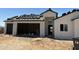 Exterior view of new construction with two-car garage with the roofing being installed at 9429 W Sandstone Mountain Dr, Casa Grande, AZ 85194