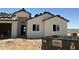 A new construction home with a light stucco exterior and black trim is being built at 9429 W Sandstone Mountain Dr, Casa Grande, AZ 85194