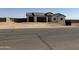 Modern home with three car garage, desert landscaping and a view of the surrounding neighborhood at 9429 W Sandstone Mountain Dr, Casa Grande, AZ 85194