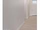 Bright hallway featuring clean white walls, baseboards and stylish flooring at 9429 W Sandstone Mountain Dr, Casa Grande, AZ 85194