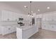 Well-designed kitchen showcases an island, stainless steel appliances, and white cabinetry at 9429 W Sandstone Mountain Dr, Casa Grande, AZ 85194
