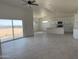 Open-concept living space featuring tile flooring, an adjacent kitchen, and bright natural light at 9429 W Sandstone Mountain Dr, Casa Grande, AZ 85194