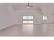 Spacious living room with vaulted ceilings, ceiling fan, and sliding glass doors to the backyard at 9429 W Sandstone Mountain Dr, Casa Grande, AZ 85194