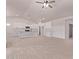 Open-concept living room and kitchen featuring white cabinets and modern lighting fixtures at 9429 W Sandstone Mountain Dr, Casa Grande, AZ 85194