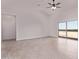 Bright living room with ceiling fan, vaulted ceilings, and a sliding glass door to the backyard at 9429 W Sandstone Mountain Dr, Casa Grande, AZ 85194