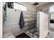 Modern tile shower with a towel and seat for comfort and accessibility at 9735 W Kirby Ave, Tolleson, AZ 85353