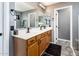 Modern bathroom with a double sink vanity, quartz countertop, and updated fixtures at 9735 W Kirby Ave, Tolleson, AZ 85353