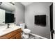 Modern half bathroom with a gray walls, tile flooring, contemporary vanity, and elegant fixture at 9735 W Kirby Ave, Tolleson, AZ 85353