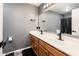 A spacious bathroom featuring double sinks, bright lighting, black accents and plenty of storage at 9735 W Kirby Ave, Tolleson, AZ 85353