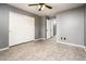 A spacious bedroom with neutral walls, ceiling fan and neutral floors allows for many decorating options at 9735 W Kirby Ave, Tolleson, AZ 85353