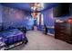 A bedroom decorated with blue walls, fun wall decor, ceiling fan, and comfortable carpeting at 9735 W Kirby Ave, Tolleson, AZ 85353