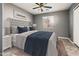 Cozy bedroom with upholstered headboard, soft bedding, and a ceiling fan at 9735 W Kirby Ave, Tolleson, AZ 85353