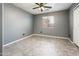 A spacious bedroom with neutral walls, ceiling fan and neutral floors allows for many decorating options at 9735 W Kirby Ave, Tolleson, AZ 85353