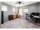 The bedroom features neutral walls and carpeting, bright lighting, and is perfect for a home office at 9735 W Kirby Ave, Tolleson, AZ 85353