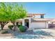 Charming stucco home featuring a two-car garage and beautiful desert landscaping at 9735 W Kirby Ave, Tolleson, AZ 85353
