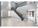 Elegant foyer with a dramatic staircase, soaring ceilings, and neutral colors create a welcoming atmosphere at 9735 W Kirby Ave, Tolleson, AZ 85353