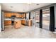 Modern kitchen featuring an island, stainless steel appliances, and granite countertops, seamlessly flowing to the outdoor patio at 9735 W Kirby Ave, Tolleson, AZ 85353