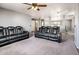 Spacious living area with plush carpeting and comfortable recliners for relaxing and entertaining at 9735 W Kirby Ave, Tolleson, AZ 85353