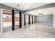 Bright living room featuring a ceiling fan, gray walls, tile flooring, and sliding doors leading to the outdoor at 9735 W Kirby Ave, Tolleson, AZ 85353