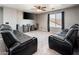 Cozy living room with comfortable recliners and large screen television for relaxed entertainment at 9735 W Kirby Ave, Tolleson, AZ 85353