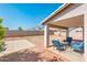 Relax on the covered patio with comfortable seating while overlooking the spacious and private backyard at 9735 W Kirby Ave, Tolleson, AZ 85353