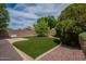 Private backyard featuring artificial grass, mature landscaping, and a brick wall at 10722 W Irma Ln, Peoria, AZ 85373