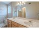 Updated bathroom featuring dual sinks, a large mirror, and a beautifully tiled walk-in shower at 10722 W Irma Ln, Peoria, AZ 85373