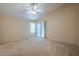 Spacious carpeted bedroom with neutral walls and a sliding glass door at 10722 W Irma Ln, Peoria, AZ 85373