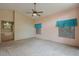 Spacious bedroom features plush carpeting, a ceiling fan, and ample natural light at 10722 W Irma Ln, Peoria, AZ 85373