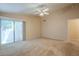Large bedroom with a sliding glass door and neutral colored carpet at 10722 W Irma Ln, Peoria, AZ 85373