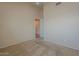 Carpeted bedroom with neutral walls, ceiling fan and entry to another room at 10722 W Irma Ln, Peoria, AZ 85373