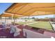 Bocce ball courts with shaded canopies, picnic tables, and benches for leisure activities at 10722 W Irma Ln, Peoria, AZ 85373