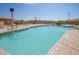 Sparkling community pool with ample lounge chairs for relaxation and sunbathing on a clear day at 10722 W Irma Ln, Peoria, AZ 85373