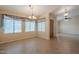 Bright dining room with tile flooring, large windows, and modern lighting fixtures at 10722 W Irma Ln, Peoria, AZ 85373