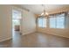 Open dining area with tile flooring, large windows, and a decorative chandelier at 10722 W Irma Ln, Peoria, AZ 85373
