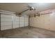 Spacious two-car garage with ample storage cabinets along the back wall and an automatic door opener at 10722 W Irma Ln, Peoria, AZ 85373