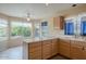 Well-lit kitchen featuring tile floors, a breakfast bar, and bright windows at 10722 W Irma Ln, Peoria, AZ 85373