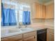 Bright kitchen featuring a double basin sink, updated faucet fixtures, and modern appliances including a dishwasher at 10722 W Irma Ln, Peoria, AZ 85373