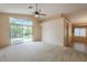 Open living room with vaulted ceilings, backyard access, and neutral carpeting at 10722 W Irma Ln, Peoria, AZ 85373