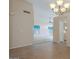 Open-concept living space with neutral colors and tile flooring, plus a view into an adjacent room at 10722 W Irma Ln, Peoria, AZ 85373
