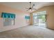 Bright living room with high ceilings, fan, and large sliding doors to the backyard at 10722 W Irma Ln, Peoria, AZ 85373