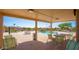 Covered patio with seating overlooking a community pool, providing a perfect spot for relaxation at 10722 W Irma Ln, Peoria, AZ 85373