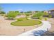 Beautiful putting green with manicured landscaping, complemented by a charming walking path at 10722 W Irma Ln, Peoria, AZ 85373